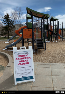 COVID-19 lockdowns - deserted playground with a sign that says "public gathering areas closed"