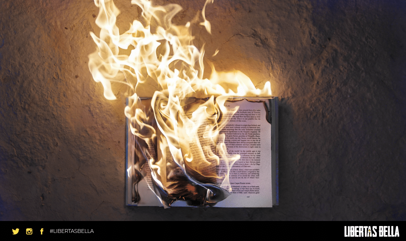 censorship quotes - book on concrete floor engulfed in flames.